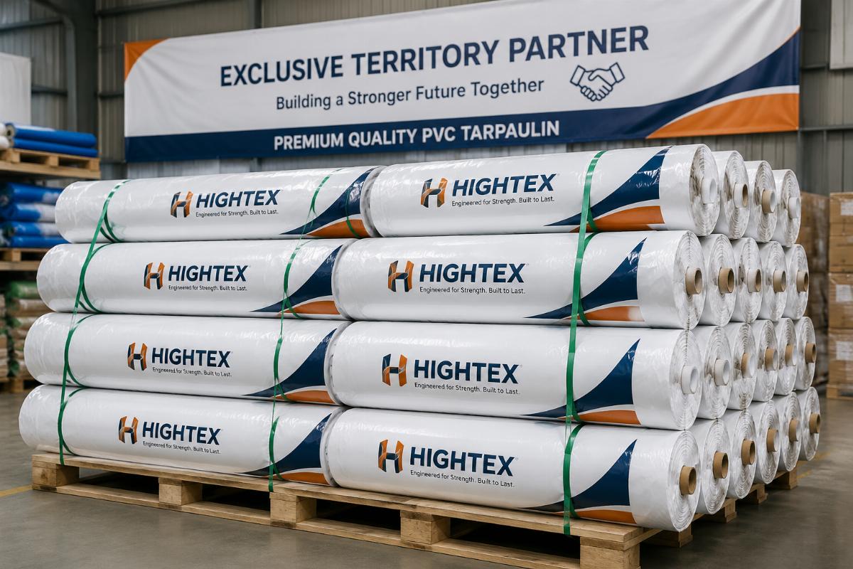 A stack of custom branded PVC tarpaulin rolls ready for shipment to an exclusive territory partner