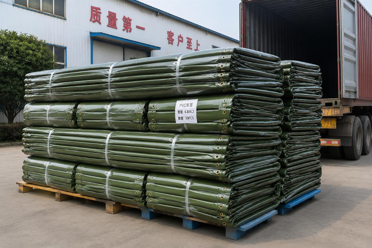 A stack of heavy duty PVC truck covers loaded for shipping at a Chinese factory