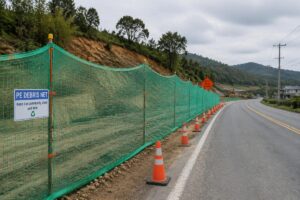 PE debris net installed along a rural road construction zone