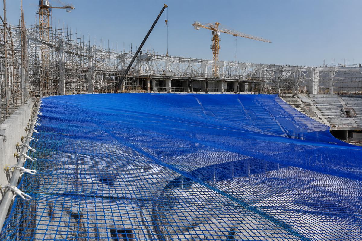Wide format splice-free debris net installed on a large venue construction site